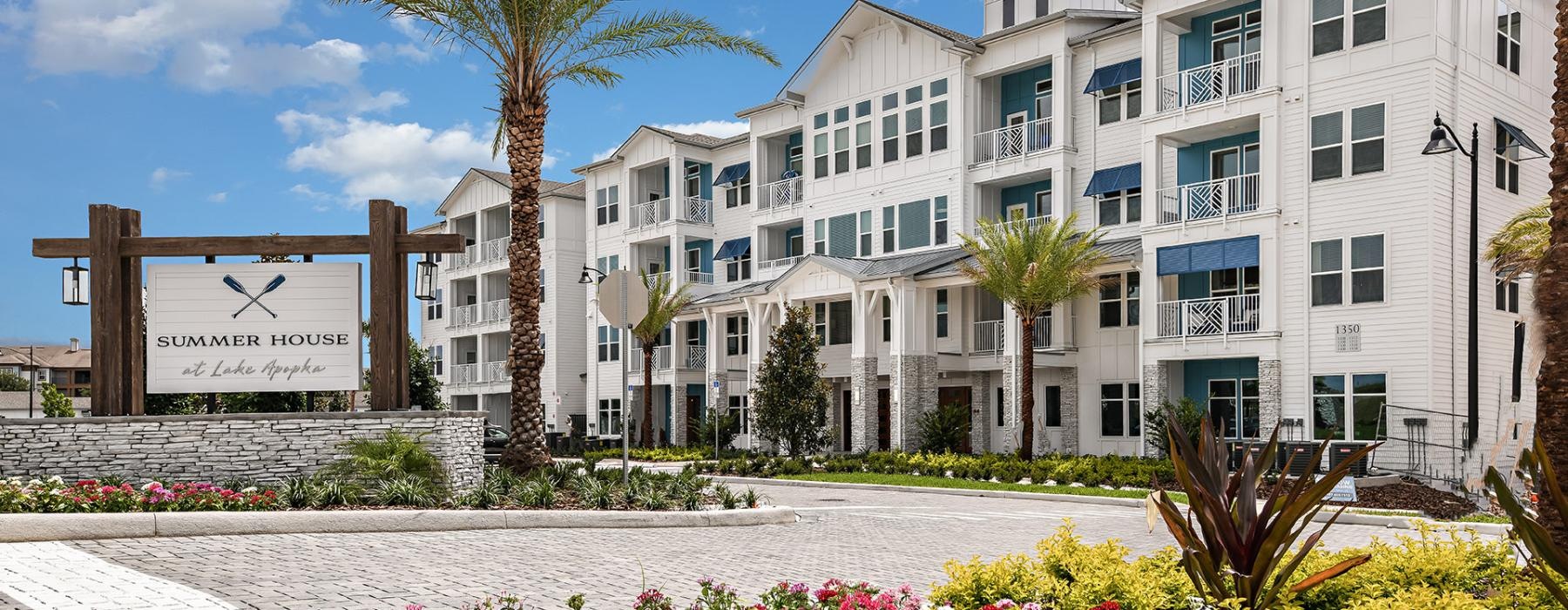a building with palm trees and flowers